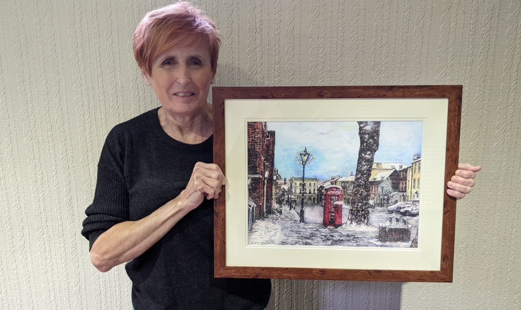 Susie delivers the framed Advent Calendar picture
